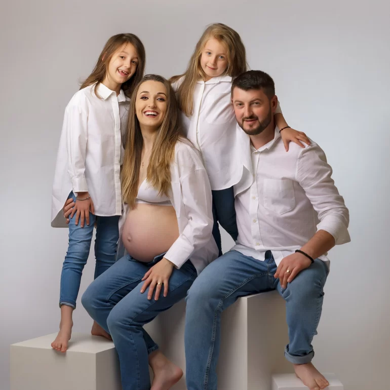 Family in white shirts and jeans; relaxed, joyful connection.