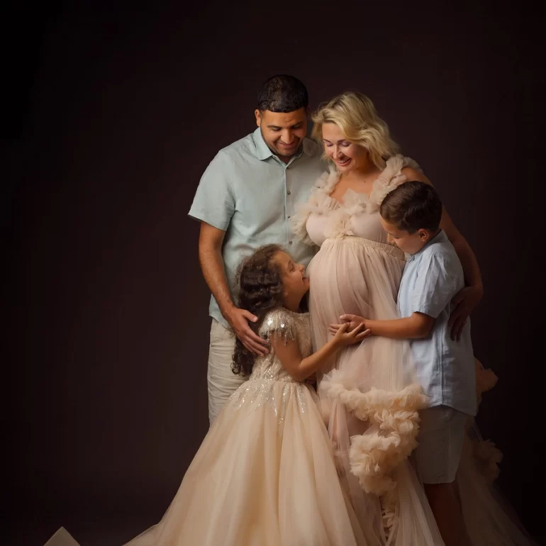 Family celebration; peach ruffled gown; warm smiles and togetherness.