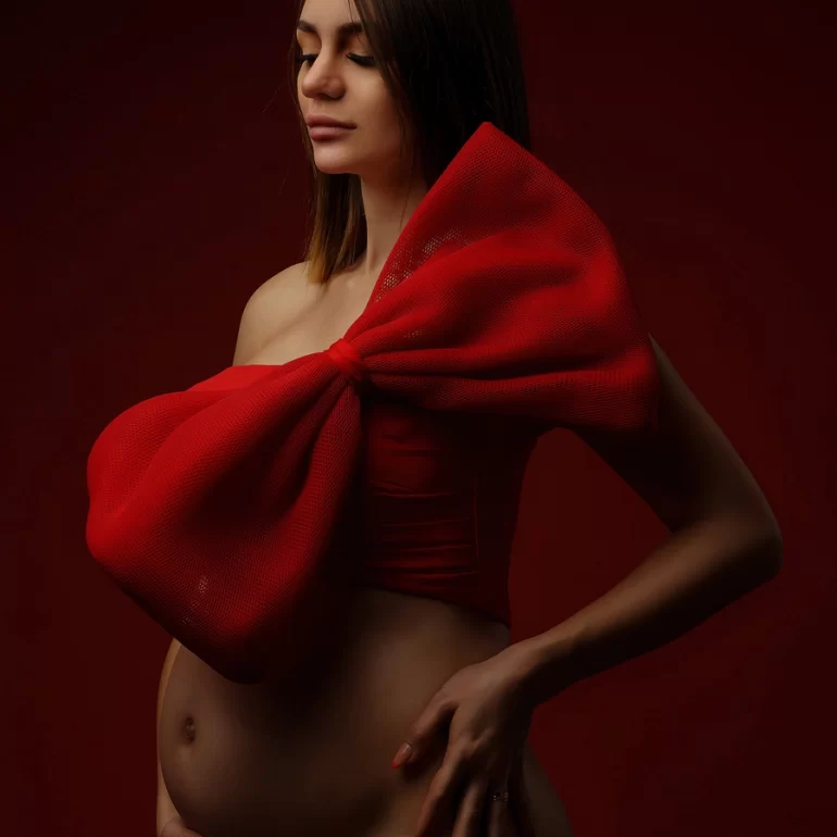 Oversized red bow; deep red background; striking, artful statement.