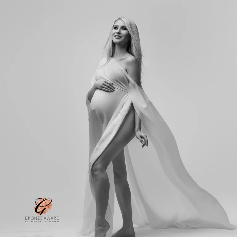 Sheer white drape; long lines and upward gaze in minimalist studio.
