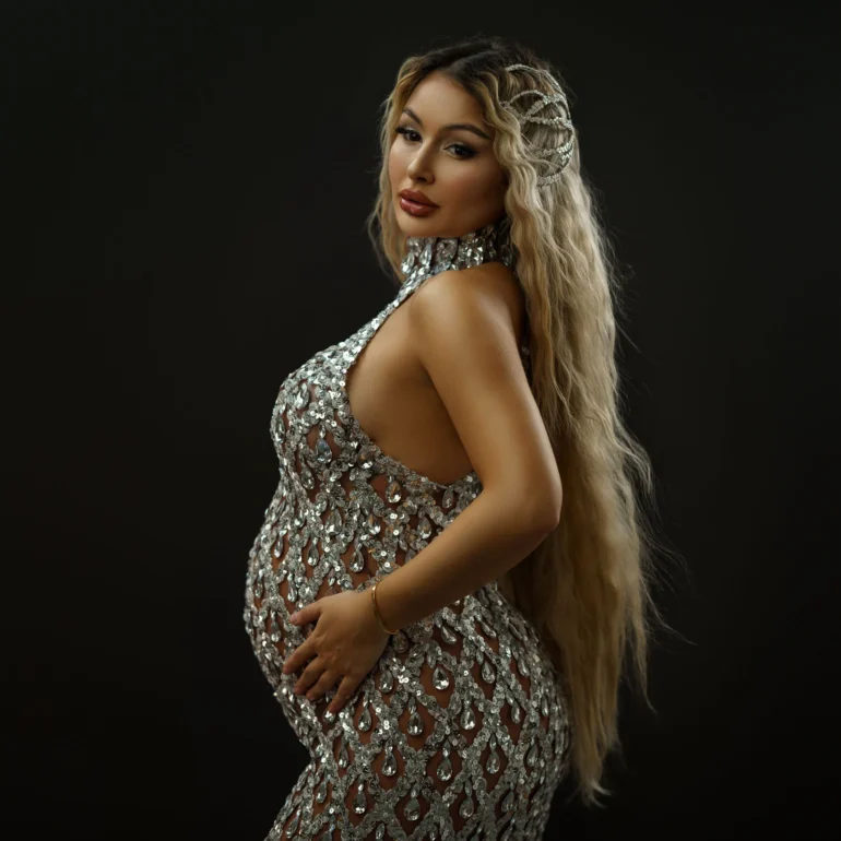 Silver sequin gown; long wavy hair with delicate accessories; confident gaze.
