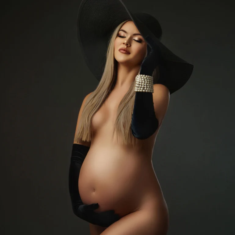 Long black gloves and hat; minimalist dark background; classic lines.
