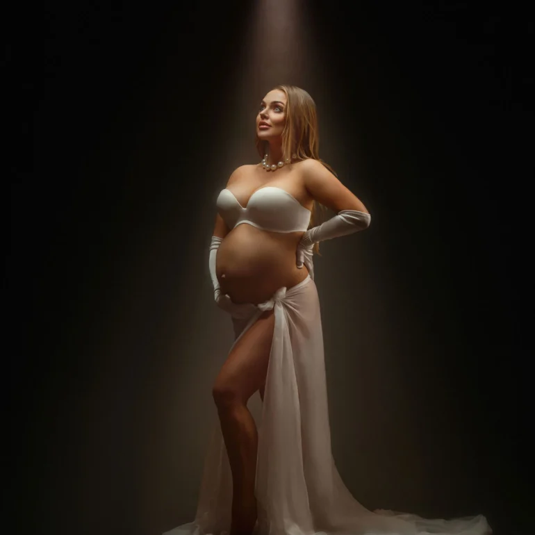 Spotlight on white gloves, pearls, and sheer fabric; classic elegance.