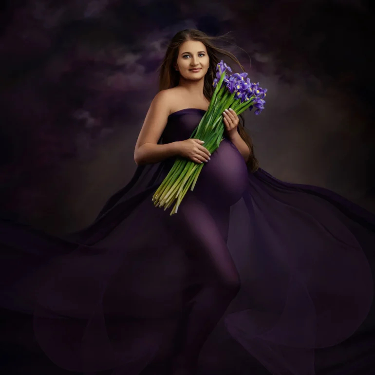 Flowing purple gown with iris bouquet; moody cloud backdrop.